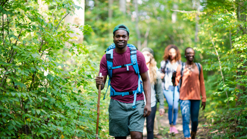 The image shows a group of students on a nature walk.
